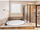 Bright bathroom with a soaking tub, a tiled shower and natural light at 18991 Round Lake Rd, Noblesville, IN 46060