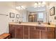 Bathroom with double vanity, framed mirror, granite countertop, and tiled shower at 18991 Round Lake Rd, Noblesville, IN 46060
