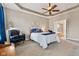 Bright and airy main bedroom features a tray ceiling, ceiling fan, and ensuite bathroom at 18991 Round Lake Rd, Noblesville, IN 46060