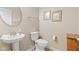 Well-lit powder room features a pedestal sink, oval mirror, framed art, and neutral decor at 18991 Round Lake Rd, Noblesville, IN 46060