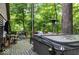 Wooden back deck features a hot tub, patio furniture, grill, and wooded view at 20417 State Road 37 N, Noblesville, IN 46060