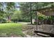 Backyard scene features a wooden deck, lush greenery, and mature trees at 20417 State Road 37 N, Noblesville, IN 46060
