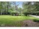 Spacious backyard featuring lush greenery, mature trees, and a shed at 20417 State Road 37 N, Noblesville, IN 46060