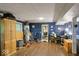 Basement featuring blue walls, wood floors, desk, exercise equipment, and a closet at 20417 State Road 37 N, Noblesville, IN 46060