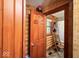 Bathroom door opens to reveal the shower curtain and chair inside, with wood-paneled walls and a small window at 20417 State Road 37 N, Noblesville, IN 46060