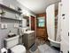 Bathroom features a classic clawfoot tub, modern vanity, wood paneling and stylish shelving for a blend of charm and convenience at 20417 State Road 37 N, Noblesville, IN 46060