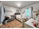 Cozy bedroom featuring a grey bed, grey chair, wood floors, and a Dior decoration at 20417 State Road 37 N, Noblesville, IN 46060