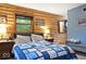 Serene bedroom showcasing wood paneled walls, a plush bed, and peaceful natural light at 20417 State Road 37 N, Noblesville, IN 46060