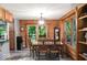 Charming dining space featuring wood paneled walls, pendant lighting, and access to the back patio at 20417 State Road 37 N, Noblesville, IN 46060