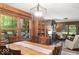 Inviting dining area featuring wood paneling, light fixture, and views to the wooded outdoors at 20417 State Road 37 N, Noblesville, IN 46060