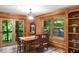 Cozy dining area featuring wood paneled walls, a stylish light fixture, and tranquil outdoor views at 20417 State Road 37 N, Noblesville, IN 46060