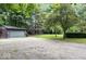 Gravel driveway leading to a charming home with a detached garage and landscaped yard at 20417 State Road 37 N, Noblesville, IN 46060