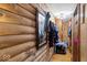 A hallway with wood-paneled walls is decorated with a mirror and coat rack, and reveals a pet kennel at 20417 State Road 37 N, Noblesville, IN 46060