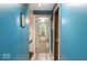Hallway leads to a bedroom with neutral carpet and a view of the outside at 20417 State Road 37 N, Noblesville, IN 46060