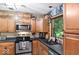 Efficient kitchen showcasing stainless steel appliances, wood cabinets and views to the outdoors at 20417 State Road 37 N, Noblesville, IN 46060