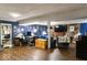 Basement with wood floors, desk, living room area, and accents on the blue walls at 20417 State Road 37 N, Noblesville, IN 46060