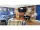 Living room featuring wood accent wall, grey sofas, a fireplace, and blue decor at 20417 State Road 37 N, Noblesville, IN 46060