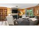 Cozy living room features wood-paneled walls, a stone fireplace, and comfortable seating at 20417 State Road 37 N, Noblesville, IN 46060