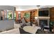 Comfortable living room with a fireplace, shelving, and an adjoining dining area at 20417 State Road 37 N, Noblesville, IN 46060