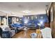 Spacious living room with a large blue sofa, wood floors, and blue accent wall at 20417 State Road 37 N, Noblesville, IN 46060