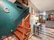 Staircase leading to the upper level, complemented by a striking blue wall and a glimpse of the kitchen at 20417 State Road 37 N, Noblesville, IN 46060