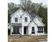 Two-story home in progress featuring black-framed windows and a peaked roof design at 21025 Thornborough Dr, Westfield, IN 46074