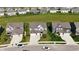 Aerial view of the neighborhood with manicured lawns, mature trees, and easy access to the street at 2358 S Stonehill Way, New Palestine, IN 46163