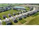 Beautiful aerial view of a suburban neighborhood with a scenic pond and well-maintained green spaces at 2358 S Stonehill Way, New Palestine, IN 46163