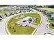 Aerial view showcasing the community pool, playground, and well-manicured landscaping in a residential neighborhood at 2358 S Stonehill Way, New Palestine, IN 46163