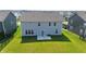 Large backyard featuring a grassy area and patio, perfect for outdoor living and entertaining at 2358 S Stonehill Way, New Palestine, IN 46163