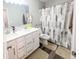 Bathroom featuring a double sink vanity, decorative mirror and a shower with a modern geometric curtain at 2358 S Stonehill Way, New Palestine, IN 46163