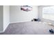 Bedroom with gray carpet, a window, and a decorative wall art, creating a serene and comfortable atmosphere at 2358 S Stonehill Way, New Palestine, IN 46163