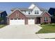 Two-story home featuring a brick-accented facade, light gray siding, and a spacious two-car garage at 2358 S Stonehill Way, New Palestine, IN 46163