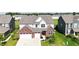 Two-story home featuring a two-car garage, brick accents, light gray siding, and a well-manicured lawn at 2358 S Stonehill Way, New Palestine, IN 46163