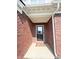 Charming brick entryway with a welcoming 'friends & Gathering' doormat and classic black front door at 2358 S Stonehill Way, New Palestine, IN 46163