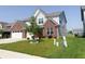 Two-story home with brick accents, light gray siding, a two-car garage, and a well-kept front yard at 2358 S Stonehill Way, New Palestine, IN 46163