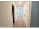 Hallway with plush carpet, multiple doors leading to rooms and closets, offering seamless transition at 2358 S Stonehill Way, New Palestine, IN 46163