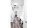 Hallway featuring hardwood floors, a bench, and a view to the pantry room with shelving at 2358 S Stonehill Way, New Palestine, IN 46163