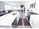Bright eat-in kitchen with stainless appliances, subway tile backsplash, white cabinets, and hardwood floors at 2358 S Stonehill Way, New Palestine, IN 46163