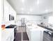 Modern kitchen features white cabinets, stainless steel appliances, and a large island with countertop seating at 2358 S Stonehill Way, New Palestine, IN 46163