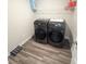 Laundry room with updated appliances, vinyl flooring, and upper shelving storage at 2358 S Stonehill Way, New Palestine, IN 46163