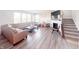 Bright living room with a cozy fireplace, plush seating, and a staircase leading to the upper level at 2358 S Stonehill Way, New Palestine, IN 46163