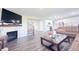 Spacious living room features hardwood floors, a fireplace, a leather sofa, and an open concept to the kitchen at 2358 S Stonehill Way, New Palestine, IN 46163