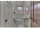 Classic bathroom with pedestal sink, tiled floors, and natural light at 250 N Home Ave, Franklin, IN 46131