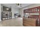Bright bedroom featuring a bunk bed, wooden floors, a desk, and a large flat-screen television at 250 N Home Ave, Franklin, IN 46131