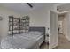 Well-lit bedroom featuring a gray upholstered bed, modern shelving, and wood floors, next to an open doorway at 250 N Home Ave, Franklin, IN 46131