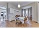 Bright dining area featuring hardwood floors, white walls, and a traditional dining table setup near the kitchen at 250 N Home Ave, Franklin, IN 46131