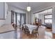 Dining room with hardwood floors, large windows, and an open layout connecting to the living area at 250 N Home Ave, Franklin, IN 46131