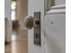 Close-up of a vintage doorknob featuring a decorated knob and bronze backplate on a white painted door at 250 N Home Ave, Franklin, IN 46131