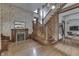 Entryway featuring a grand wooden staircase, fireplace, and hardwood floors with floral wallpaper at 250 N Home Ave, Franklin, IN 46131